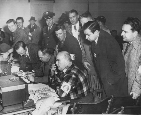 Government officials look on.